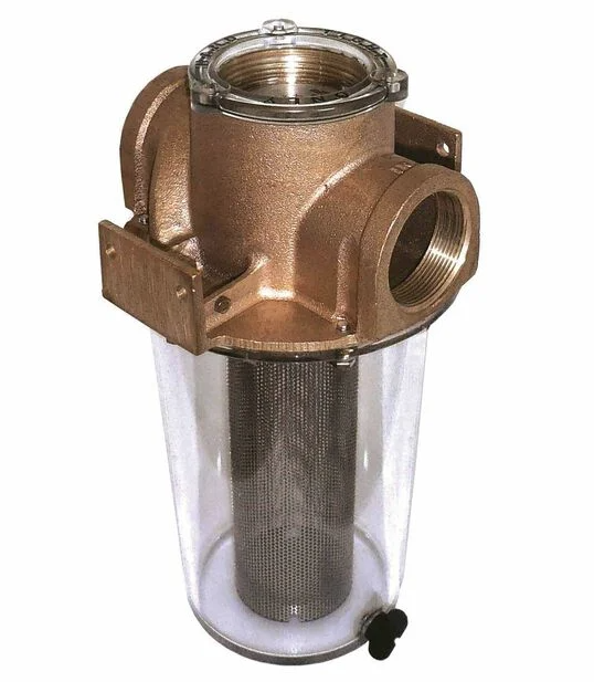 Close-up image of a Groco bronze strainer with clear canister housing and narrow cylindrical sea strainer basket inside. 